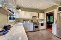 Bright kitchen interior with white cabinets and marble counter top Royalty Free Stock Photo