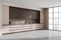 Bright kitchen room interior with brown cupboard, panoramic window