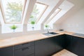 Bright kitchen with slanted ceiling. Royalty Free Stock Photo