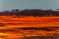 Bright orange clouds at sunset, like lava. Royalty Free Stock Photo