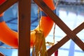A bright lifebuoy is tied to the railing of the bridge.