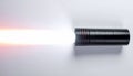 Bright Light Beam from a Tactical Black Flashlight Royalty Free Stock Photo
