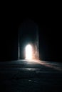 Bright Light Emerging from Dark Arched Doorway Royalty Free Stock Photo