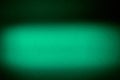 Bright light green blurred textural cloud of light on a dark background Royalty Free Stock Photo