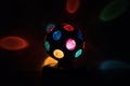 Multicolored Disco-ball lamp in a black backgound