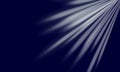 Bright light rays on dark blue background Royalty Free Stock Photo