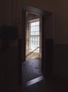 Bright light from stairwell window, seen from a dark doorway.
