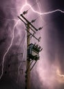 Bright lightning bolts striking electric power pylon tower cables and sub station strike. Electricity discharge cloud to ground Royalty Free Stock Photo