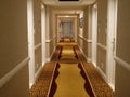 Bright lights shine down on the elegantly decorated hallway of a beautiful motel Royalty Free Stock Photo