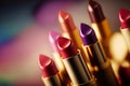 Bright lipstick of different colors shades of colored lipstick for lips. Professional makeup tool, blurred background Royalty Free Stock Photo