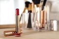 Bright lipstick in gold on dressing table, space for text Royalty Free Stock Photo