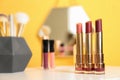 Bright lipsticks in gold tubes on dressing table Royalty Free Stock Photo