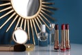 Bright lipsticks in gold tubes on dressing table Royalty Free Stock Photo