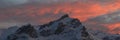 Bright lit clouds over snow covered mountains Royalty Free Stock Photo