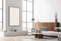 Bright living room interior with empty white poster, panoramic window Royalty Free Stock Photo