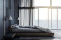 Bright loft bedroom interior with panoramic window and city view, curtain and other objects. Royalty Free Stock Photo
