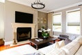 Bright luxury living room with fireplace and tv Royalty Free Stock Photo
