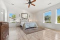Bright Main Bedroom With Windows, Expansive Primary Bedroom Featuring Natural Light And Elegant Decor Royalty Free Stock Photo