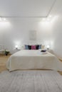 Bright Minimal Bedroom Interior with Cozy Bed and Soft Lighting Royalty Free Stock Photo