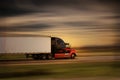 Modern big rig semi truck and trailer in motion on a highway Royalty Free Stock Photo