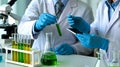 Scientists working in a laboratory with test tubes conducting scientific research and experimenting using technology Royalty Free Stock Photo