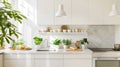 Bright and Modern White Kitchen with Green Plants and Fresh Vegetables on Countertop. Royalty Free Stock Photo