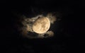 Bright moon surrounded by the silky clouds at night