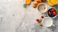 Bright morning breakfast setup with coffee and croissants. fresh start with healthy food choices, top view on marble Royalty Free Stock Photo