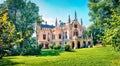 Bright morning view of Sturdza castle. Picturesque summer scene of the green park in Miclauseni monastery. Colorful landscape of R