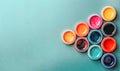 Bright, mother-of-pearl, multicolored open jar with paint on a green background in the form of a left pointer.