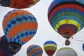 Bright multi-colored hot air balloons flying high in the sky during the aeronautic festival