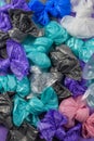 Bright multi-colored plastic garbage bags rolled into bows Royalty Free Stock Photo