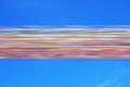 Bright multi-colored satin ribbons develop against the blue sky. Multi-colored line. Ostend, Belgium