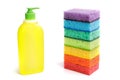 Bright multi-colored sponges and a plastic bottle of liquid for sanitary work, washing dishes, cleaning the bathroom and other Royalty Free Stock Photo