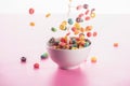 Bright multicolored breakfast cereal in bowl with milk splash Royalty Free Stock Photo