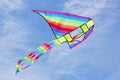 Bright multicolored kite in blue sky Royalty Free Stock Photo