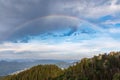 Rainbow with colors on a cloudy sky over a valley of the Rhodope Mountains Royalty Free Stock Photo