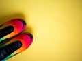 Bright multicolored sneakers on a yellow background. flat lay