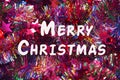 Bright multicolored tinsel with stars, white inscription Merry Christmas. Holiday, Christmas Royalty Free Stock Photo
