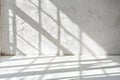 Bright natural light illuminating empty white room with shadows of window creating geometric pattern on wall and floor Royalty Free Stock Photo