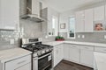 Bright and neutral kitchen with glossy gray subway tile backsplash Royalty Free Stock Photo