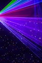 Bright nightclub red, green, purple, white, pink, blue laser lights cutting through smoke machine smoke making light patterns Royalty Free Stock Photo