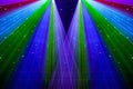 Bright nightclub red, green, purple, white, pink, blue laser lights cutting through smoke machine smoke making light patterns