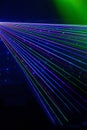 Bright nightclub red, green, purple, white, pink, blue laser lights cutting through smoke machine smoke making light patterns