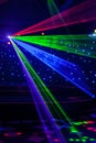 Bright nightclub red, green, purple, white, pink, blue laser lights cutting through smoke machine smoke making light and rainbow Royalty Free Stock Photo