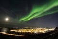 Bright northern lights above TromsÃ¸ city, Norway