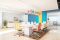 bright office space with white conference table and colorful ergonomic chairs