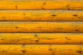 Bright orange background consisting of cylindrical logs