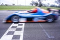 Car crossing finish line at racetrack Royalty Free Stock Photo