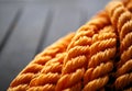 Orange braided nylon rope in tangled coil black background